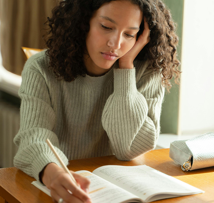 A student sitting at a desk reviewing notes