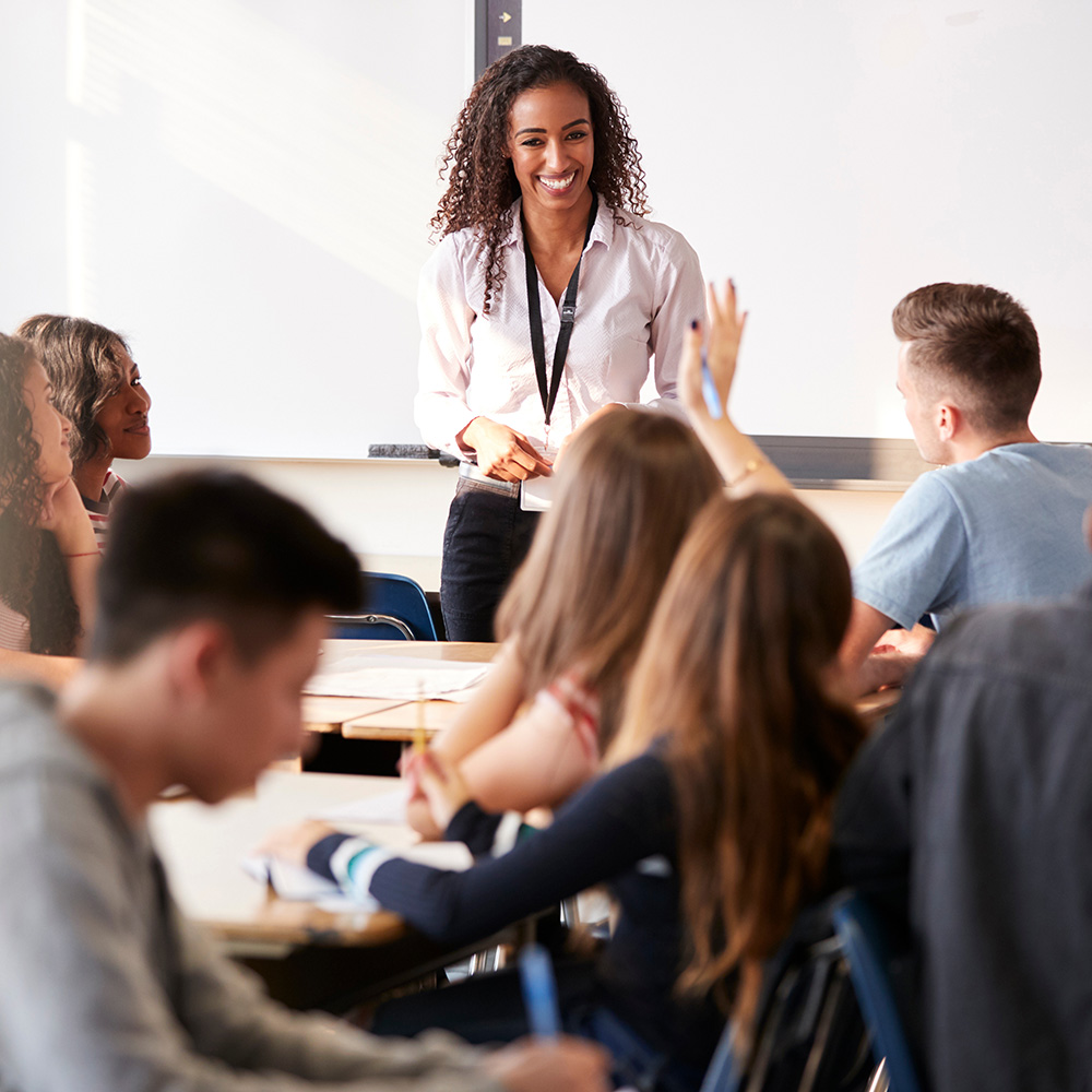 A teacher teaching in front of a class of students